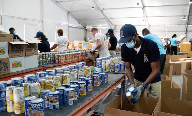 Students from the Coast Guard Basic Training Course offer a helping hand