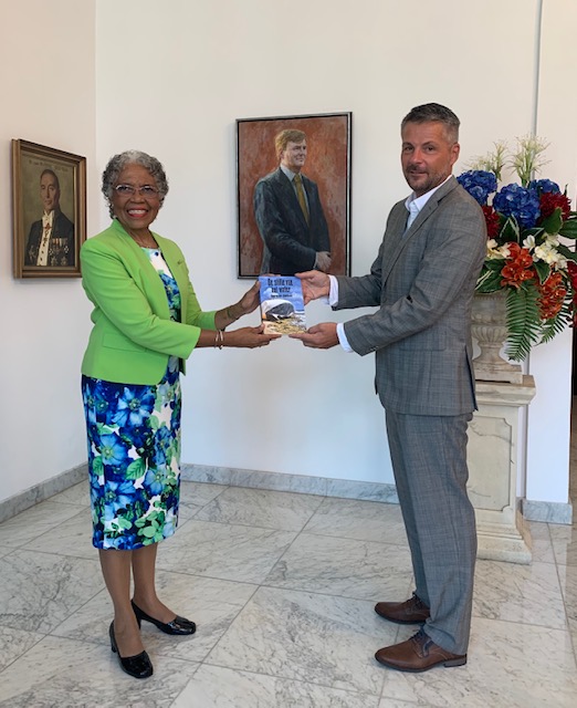 Governor receives book on human trafficking and people smuggling